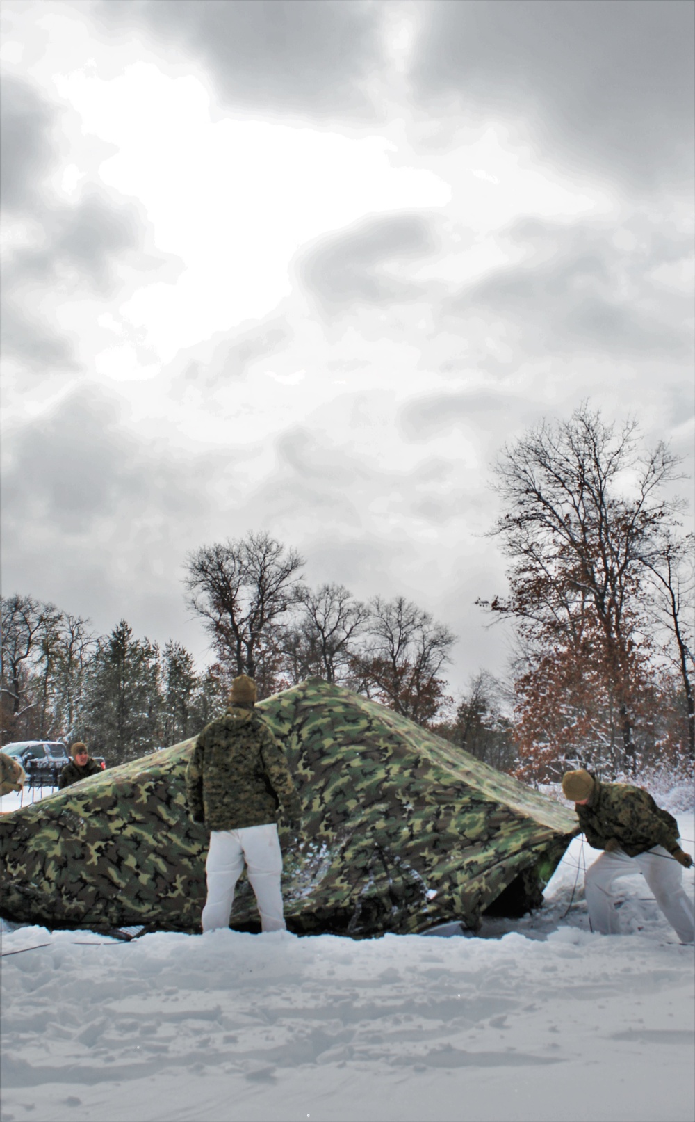 Fort McCoy CWOC class 21-03 students raise Artic tents during training scenario