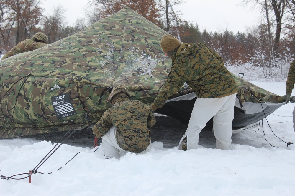 Fort McCoy CWOC class 21-03 students raise Artic tents during training scenario