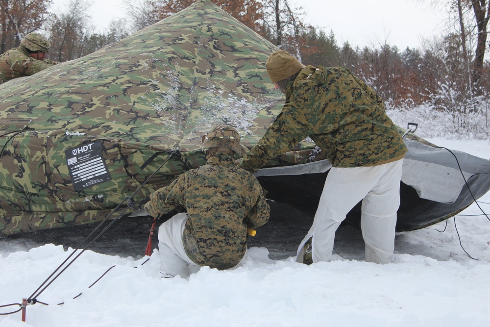 Fort McCoy CWOC class 21-03 students raise Artic tents during training scenario