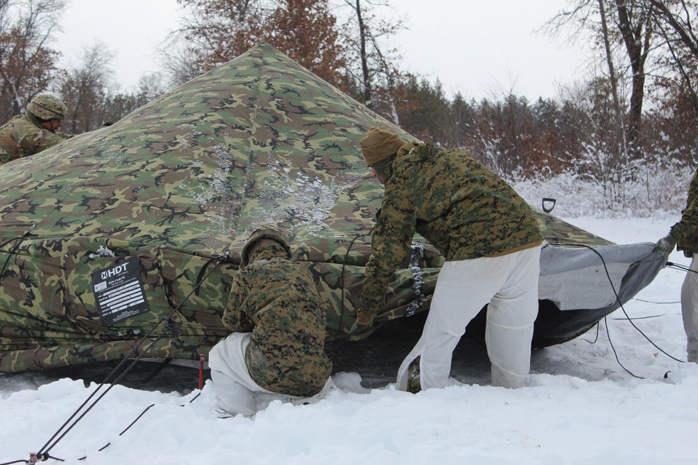 Fort McCoy CWOC class 21-03 students raise Artic tents during training scenario