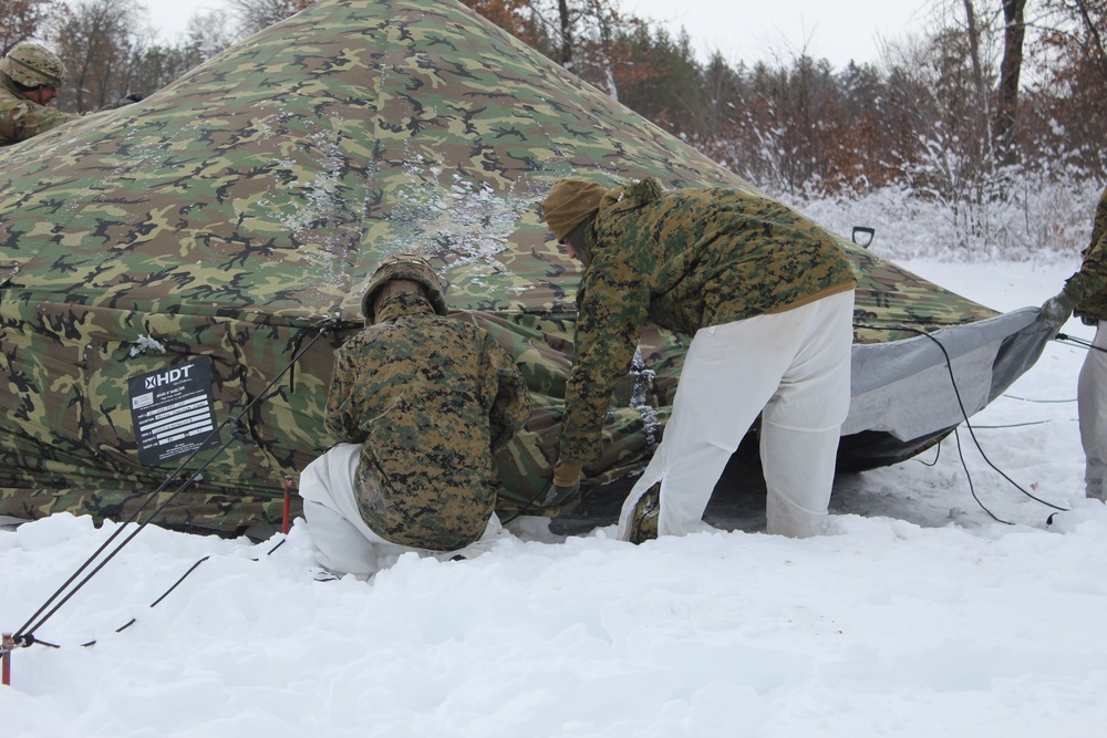 Fort McCoy CWOC class 21-03 students raise Artic tents during training scenario