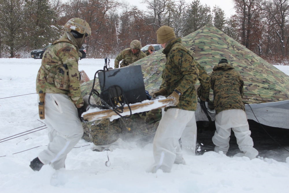 Fort McCoy CWOC class 21-03 students raise Artic tents during training scenario