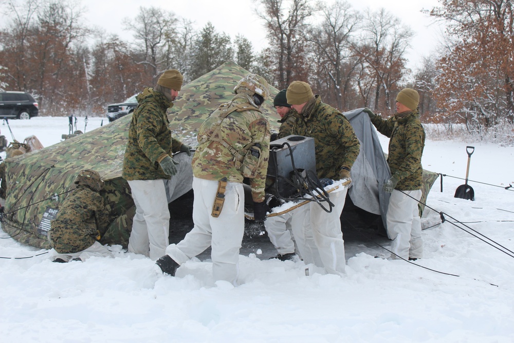 Fort McCoy CWOC class 21-03 students raise Artic tents during training scenario