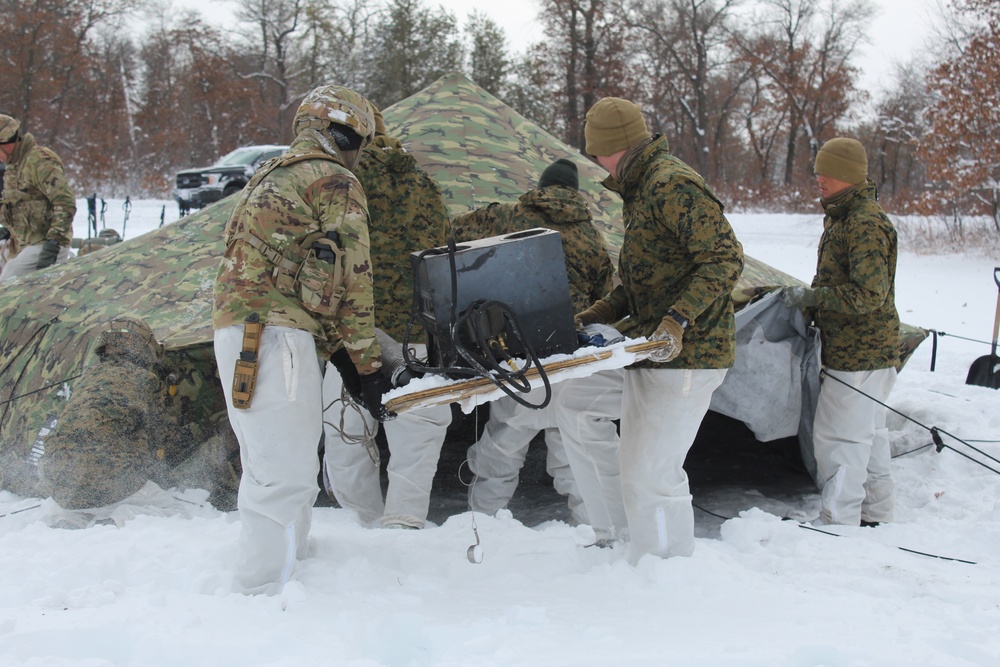 Fort McCoy CWOC class 21-03 students raise Artic tents during training scenario