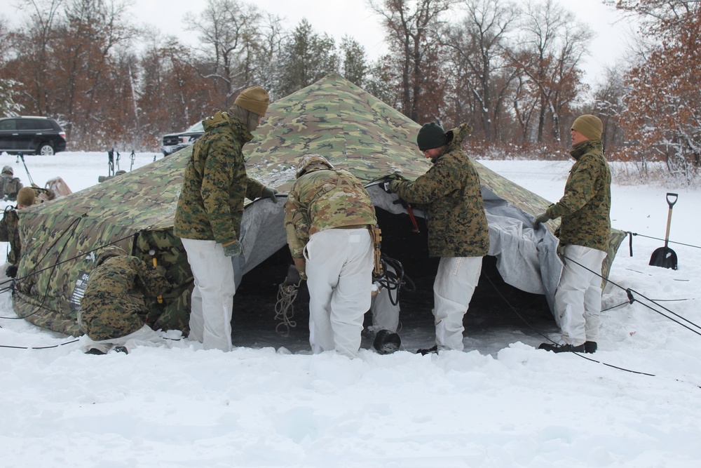 Fort McCoy CWOC class 21-03 students raise Artic tents during training scenario