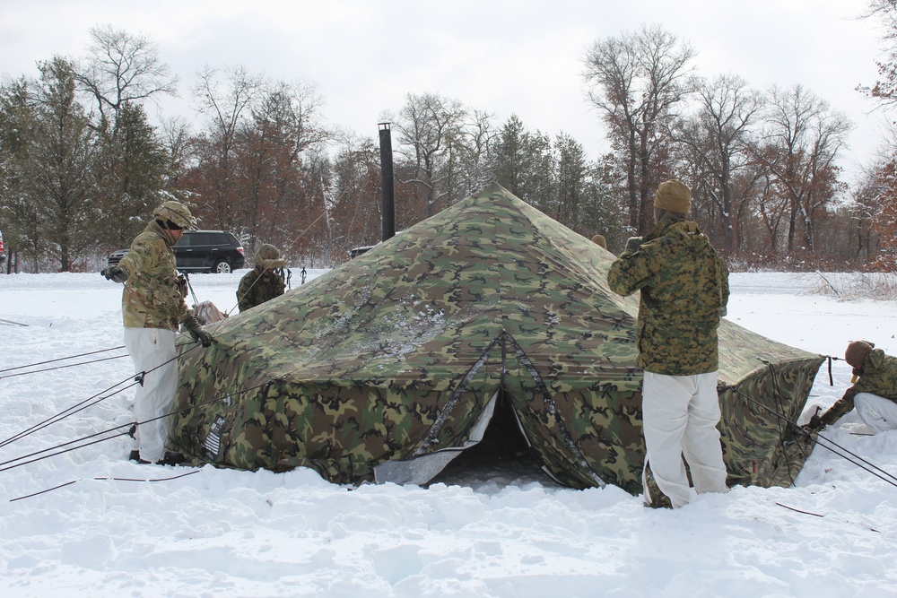 Fort McCoy CWOC class 21-03 students raise Artic tents during training scenario