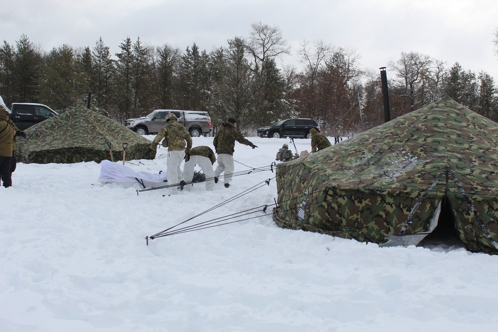 Fort McCoy CWOC class 21-03 students raise Artic tents during training scenario