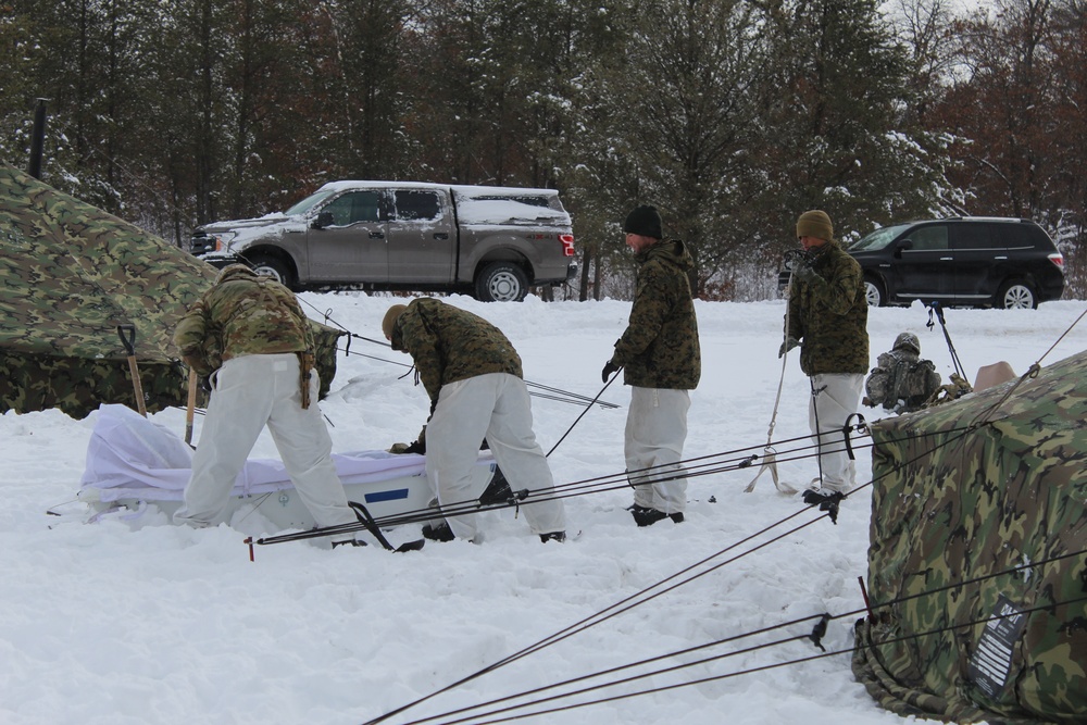 Fort McCoy CWOC class 21-03 students raise Artic tents during training scenario