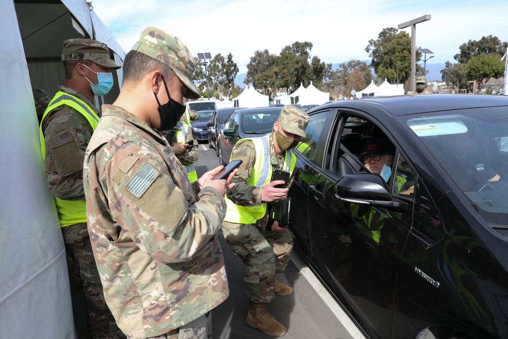 Film and TV actor Danny DeVito poses for photos with Cal Guard and active duty Soldiers after receiving vaccine at Cal Sate LA