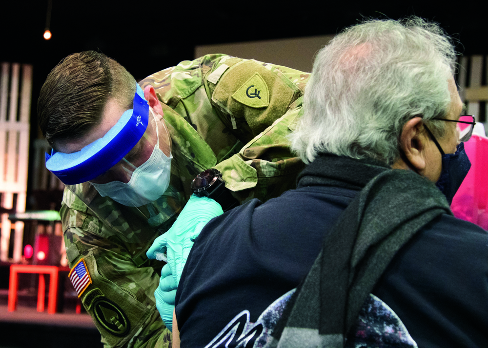 Michigan National Guard Soldier vaccinates family in childhood church