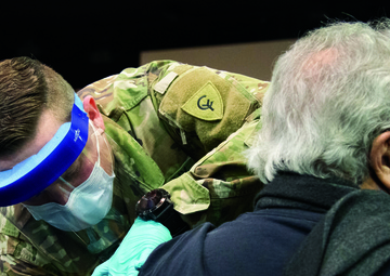 Michigan National Guard Soldier vaccinates family in childhood church