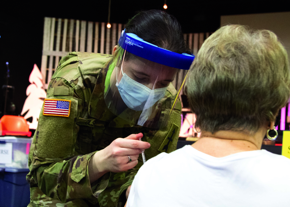 Michigan National Guard Soldier vaccinates family in childhood church
