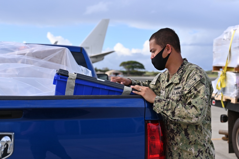 Logisticians deliver high-priority requisitions to a crew providing carrier onboard delivery (COD) support to the Nimitz Carrier Strike Group