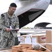 Logisticians deliver high-priority requisitions to a crew providing carrier onboard delivery (COD) support to the Nimitz Carrier Strike Group