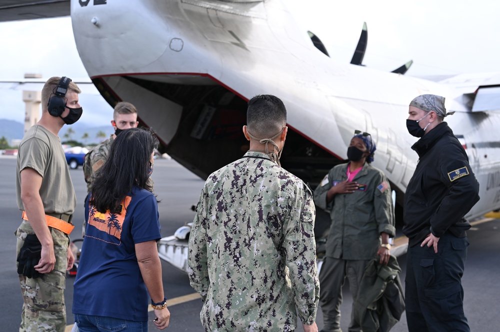 Logisticians deliver high-priority requisitions to a crew providing carrier onboard delivery (COD) support to the Nimitz Carrier Strike Group