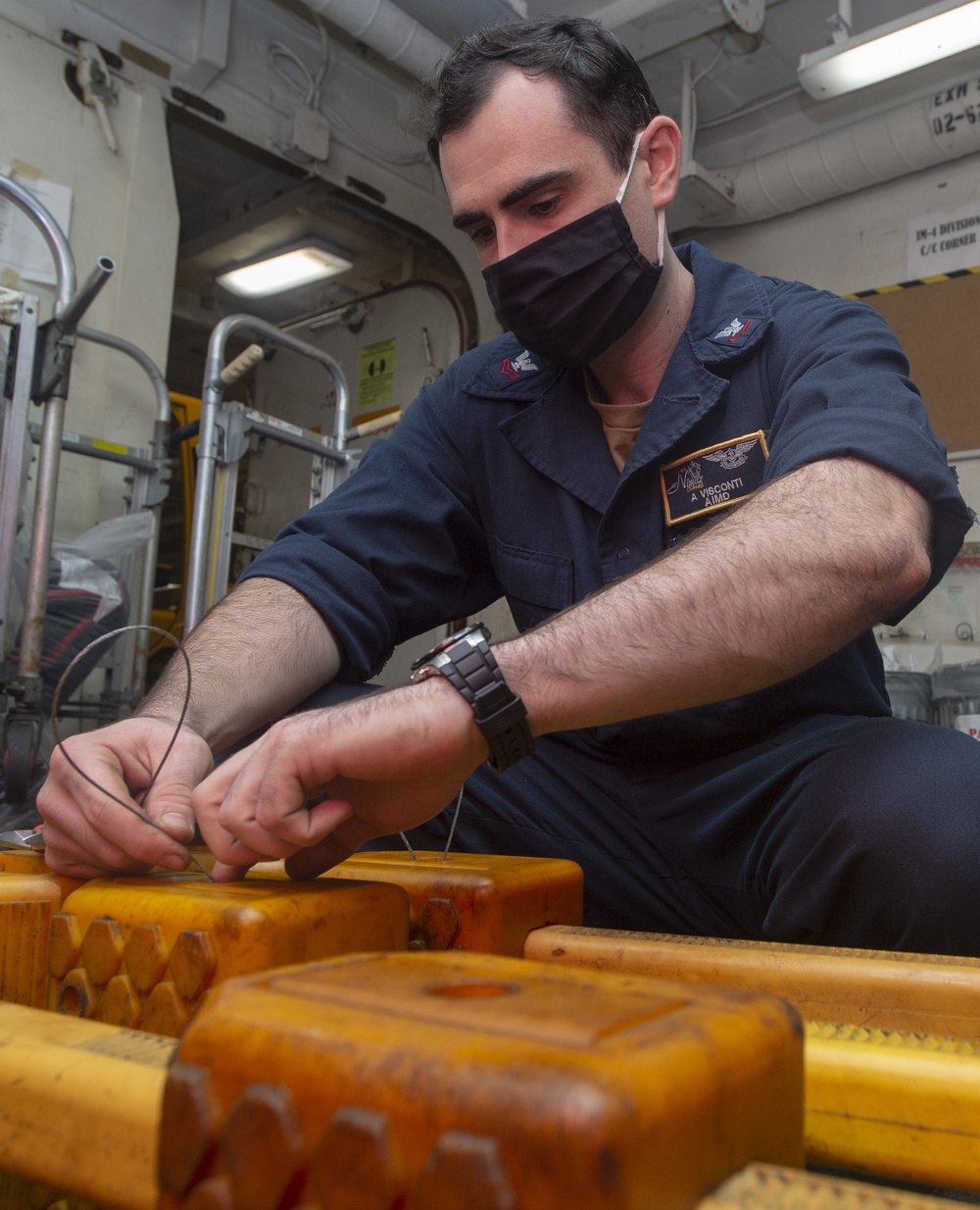 Sailor Places Lanyards On Chocks