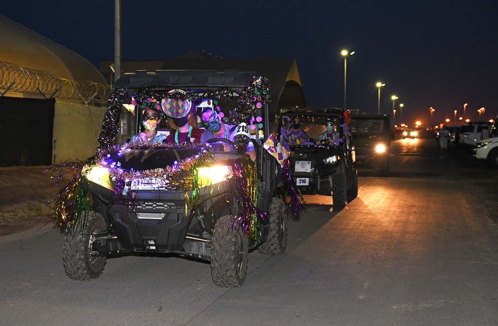 Forward-deployed service members and base personnel participate in the annual MWR Mardi Gras themed “gator parade,”