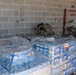 Soldier prepares water for delivery to Texans
