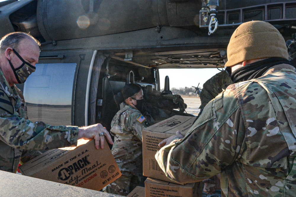 Soldiers load food for Texans into Blackhawk