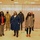 Michigan State Representatives Visit a Community Vaccination Event A group of eight people pose for a formal group photo inside what appears to be a large indoor facility, likely a vaccination or community event site. Two individuals are wearing military camouflage uniforms, while the others are in civilian attire. All individuals are wearing face masks, consistent with COVID-19 pandemic safety protocols.