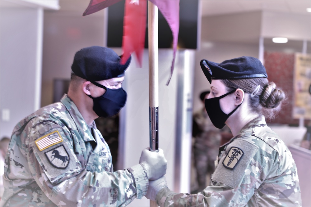 Sgt. 1st Class Stephanie Cates receiving the guidon from Col. Huy Luu