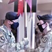 Sgt. 1st Class Stephanie Cates receiving the guidon from Col. Huy Luu