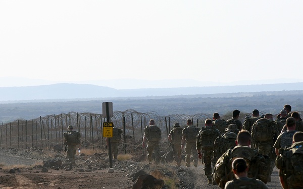 U.S. Soldiers, Airmen and Sailors march to the crash site of a U-28 aircraft which went down nine years ago near Chabelley Airfield on Feb 18, 2021