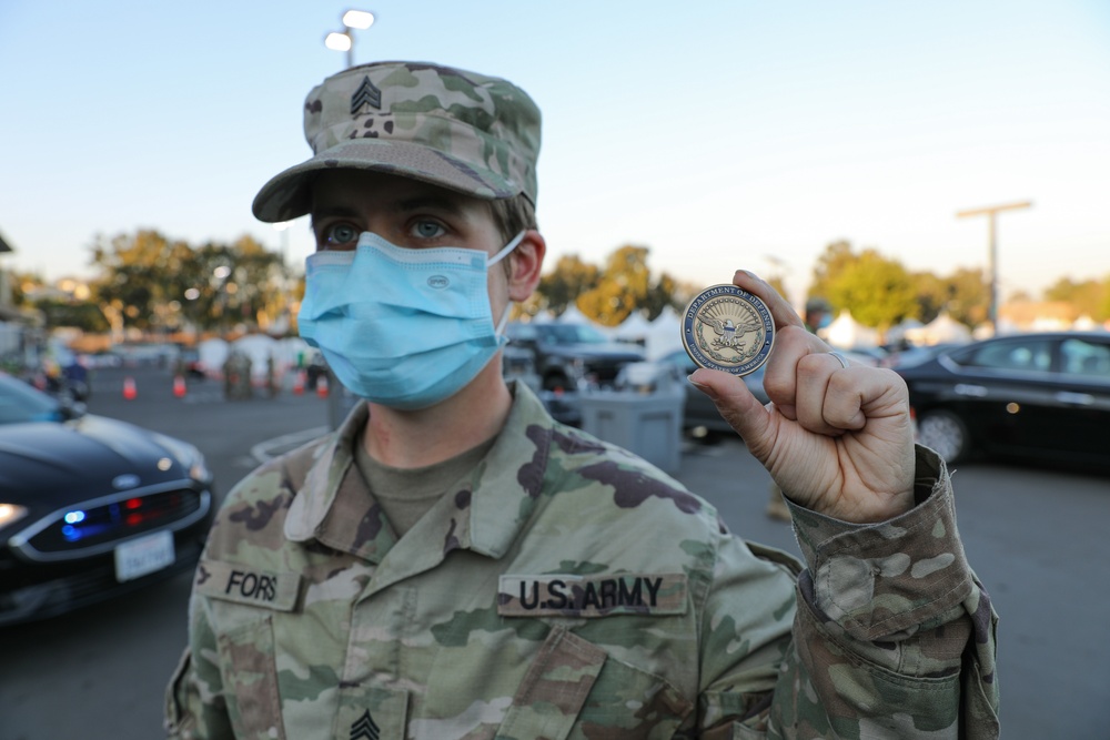 Cal Guard Soldier receives challenge coin from Secretary of Defense