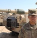 Spc. Isaiah Cabrera from Hemet, CA, a tank driver with 1st Battalion, 6th Infantry Regiment, 2nd Brigade Combat Team, 1st Armored Division, poses in front of an M-1 Abrams tank