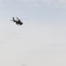 A Kuwait Land Forces Apache helicopter fires rounds down range during exercise Al Tahreer