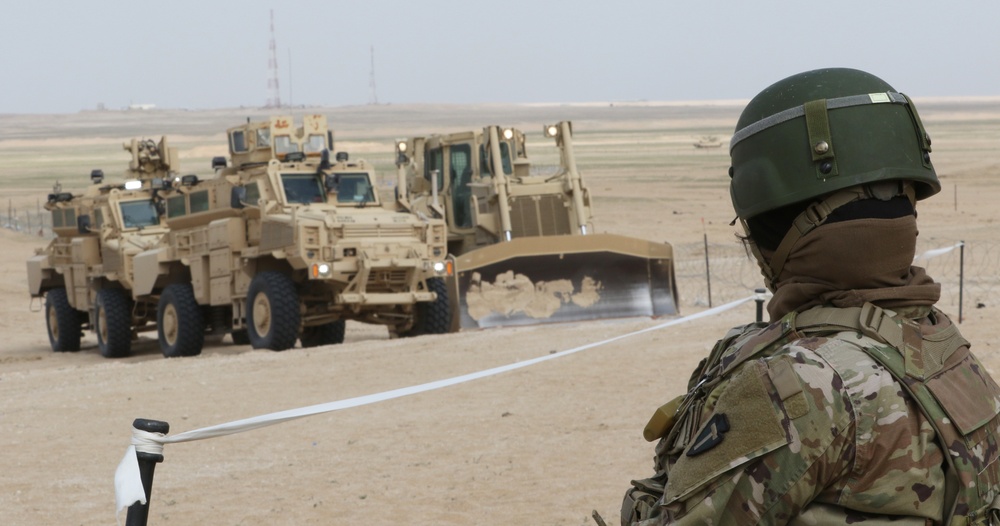Task Force Spartan Soldier watches live-fire exercise, Al Tahreer 21
