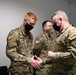 U.S. Army Maj. General Christopher Mohan presents his coin to Alaska Army National Guard Specialist Matthew Goudy.