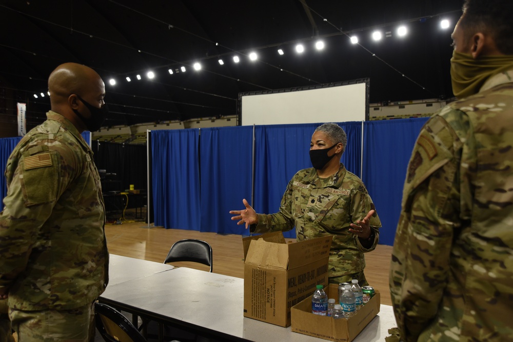 U.S. Air Force Lt. Col. Countess Cooper, a chaplain with the 113th Wing, District of Columbia Air National Guard, speaks with 1st Sgt. Marcus Boykin and and Senior Master Sgt. Roderick K. D. Henderson at the D.C. Armory in Washington, D.C., Feb. 17, 2021