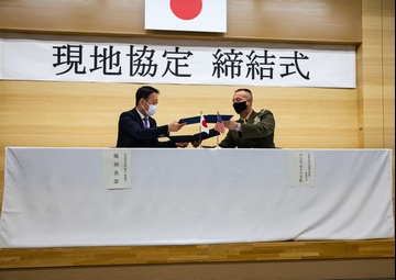 Col. Lance Lewis and Yoshihiko Fukuda co-sign Atago Humanitarian Assistance Local Implementation Agreement