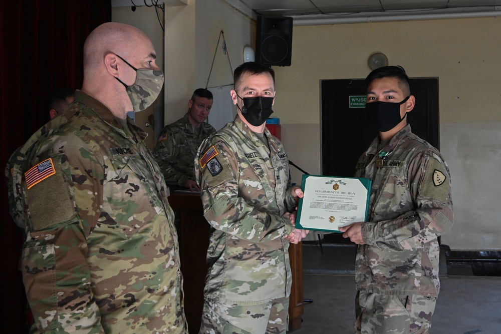 Alaska Army National Guard Specialist Lester Tuazon, 297th Regional Support Group, receives an Army Commendation Medal.