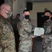 Alaska Army National Guard Specialist Lester Tuazon, 297th Regional Support Group, receives an Army Commendation Medal.