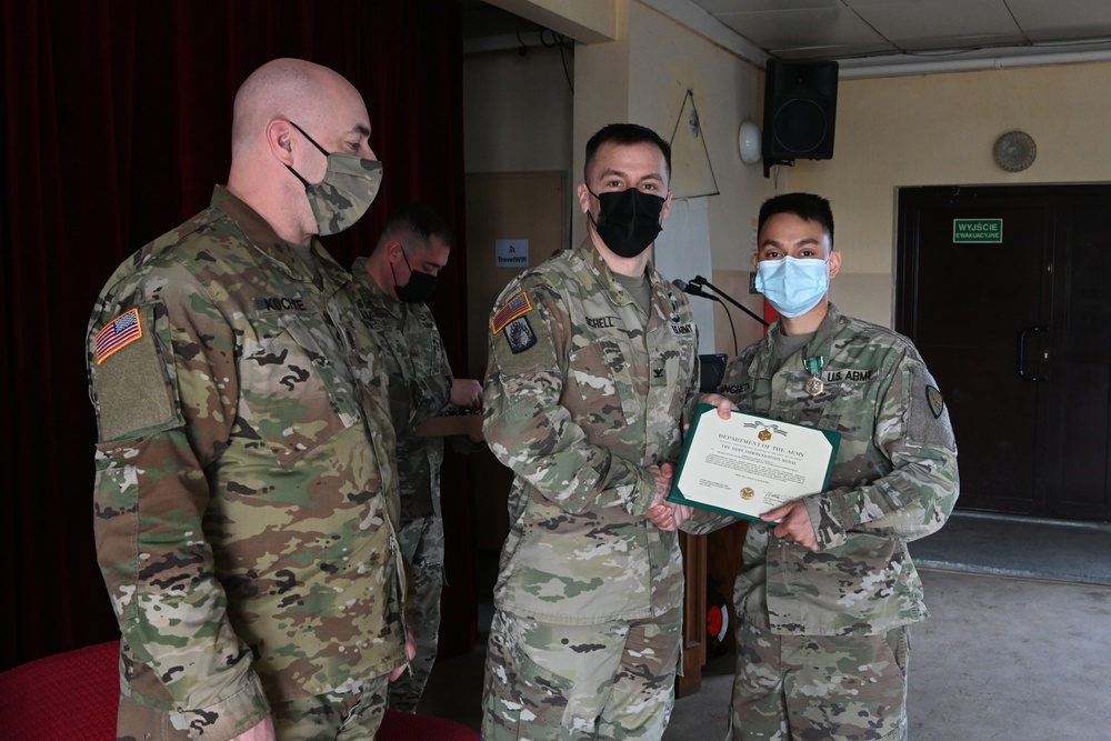 Alaska Army National Guard Specialist Harvey Ancheta, 297th Regional Support Group, receives an Army Commendation Medal.