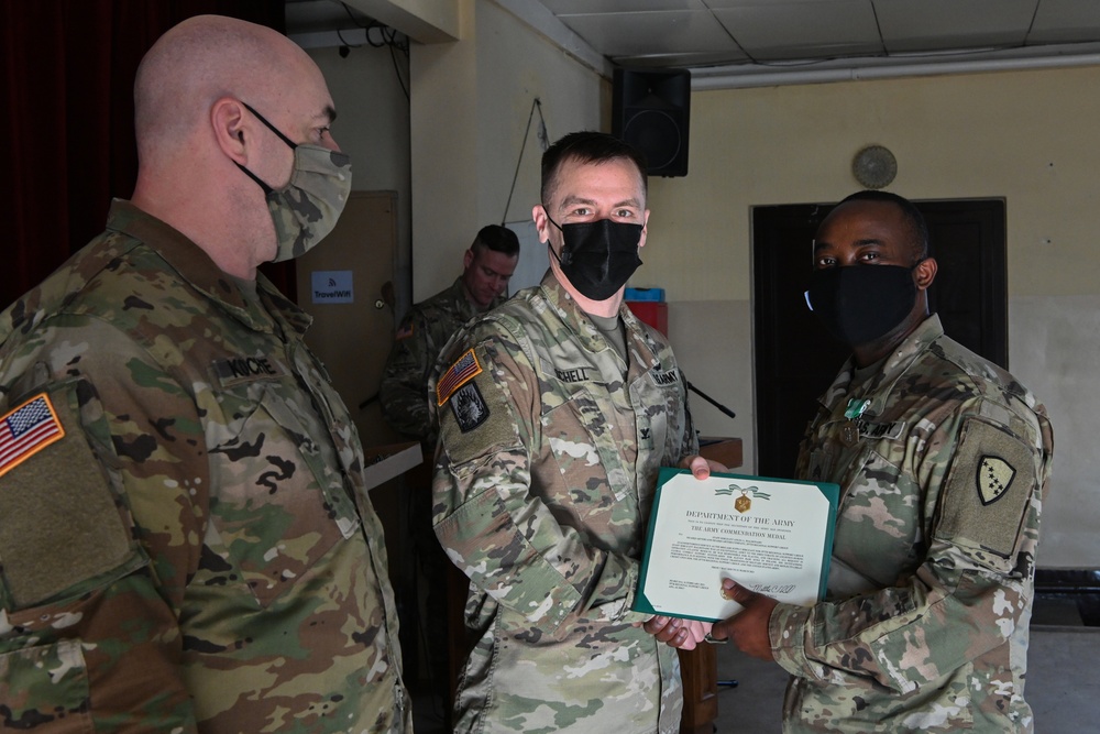 Alaska Army National Guard Sergeant Emmanuel Nfonoyim, 297th Regional Support Group, receives an Army Commendation Medal.