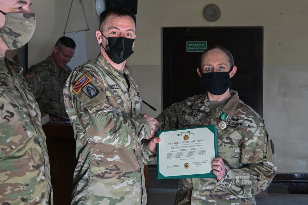 Alaska Army National Guard Staff Sergeant Kelly McLachlan, 297th Regional Support Group, receives an Army Commendation Medal.