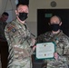 Alaska Army National Guard Staff Sergeant Kelly McLachlan, 297th Regional Support Group, receives an Army Commendation Medal.