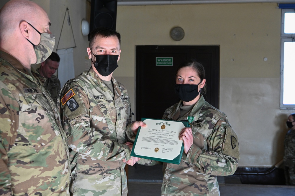 Alaska Army National Guard Staff Sergeant Bethany Hendren, 297th Regional Support Group, receives an Army Commendation Medal.