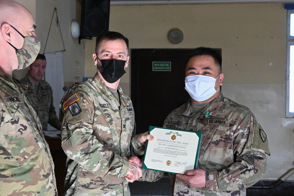 Alaska Army National Guard Staff Sergeant Jason Nocelo, 297th Regional Support Group, receives an Army Commendation Medal.