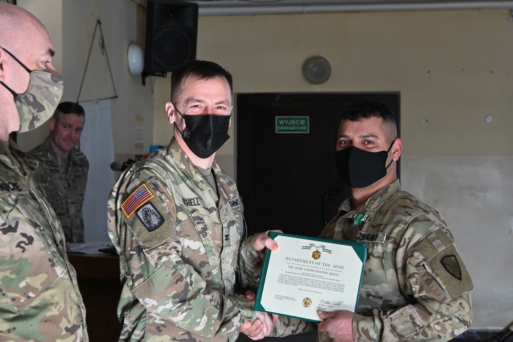 Alaska Army National Guard Specialist Nathan Aklines, 297th Regional Support Group, receives an Army Commendation Medal.