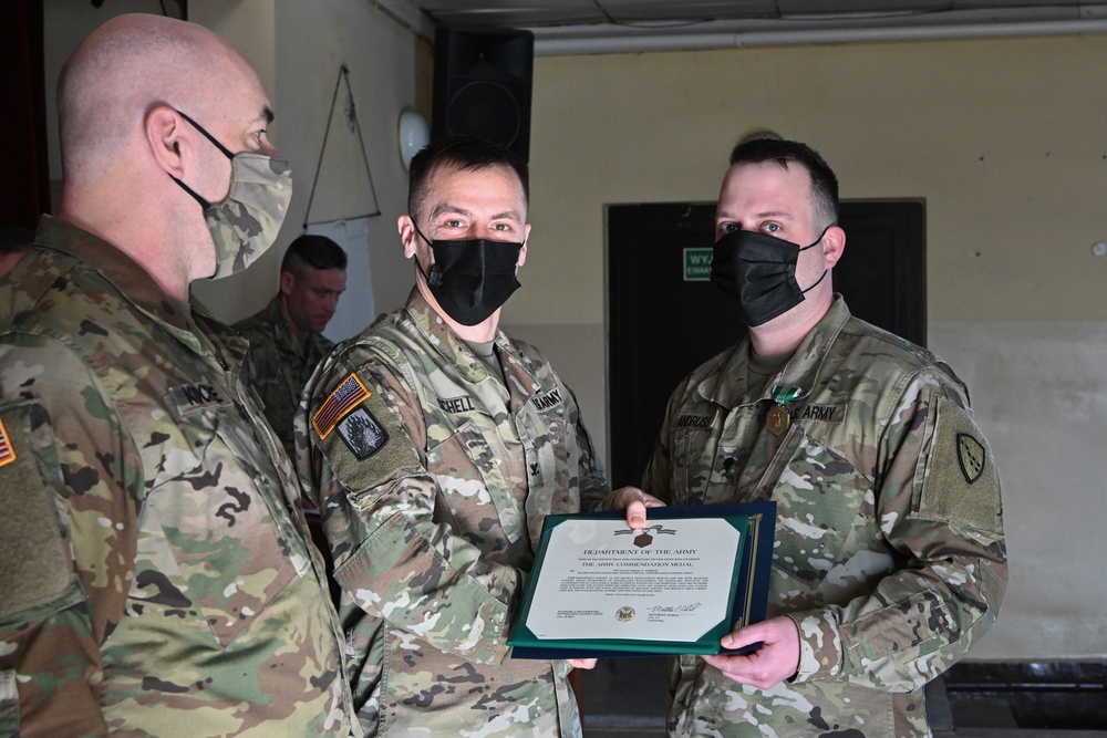 Alaska Army National Guard Specialist Mikkel Andruss, 297th Regional Support Group, receives an Army Commendation Medal.