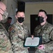 Alaska Army National Guard Specialist Mikkel Andruss, 297th Regional Support Group, receives an Army Commendation Medal.