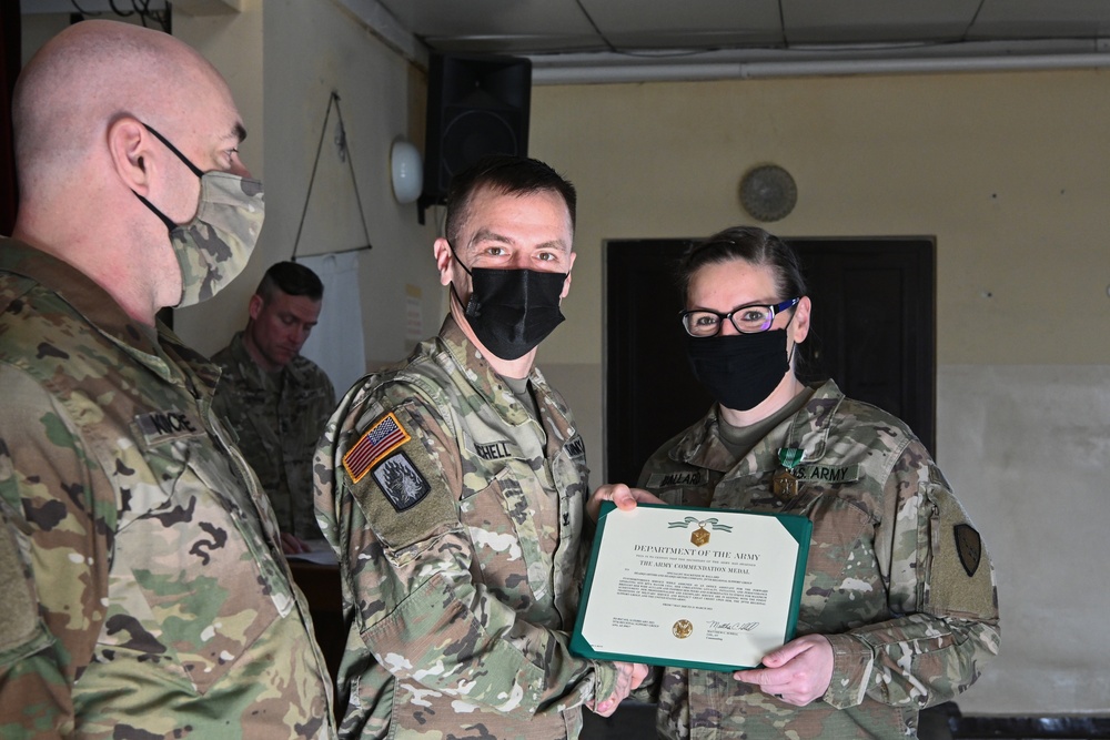 Alaska Army National Guard Specialist Mackenzie Ballard, 297th Regional Support Group, receives an Army Commendation Medal.