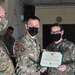 Alaska Army National Guard Specialist Mackenzie Ballard, 297th Regional Support Group, receives an Army Commendation Medal.