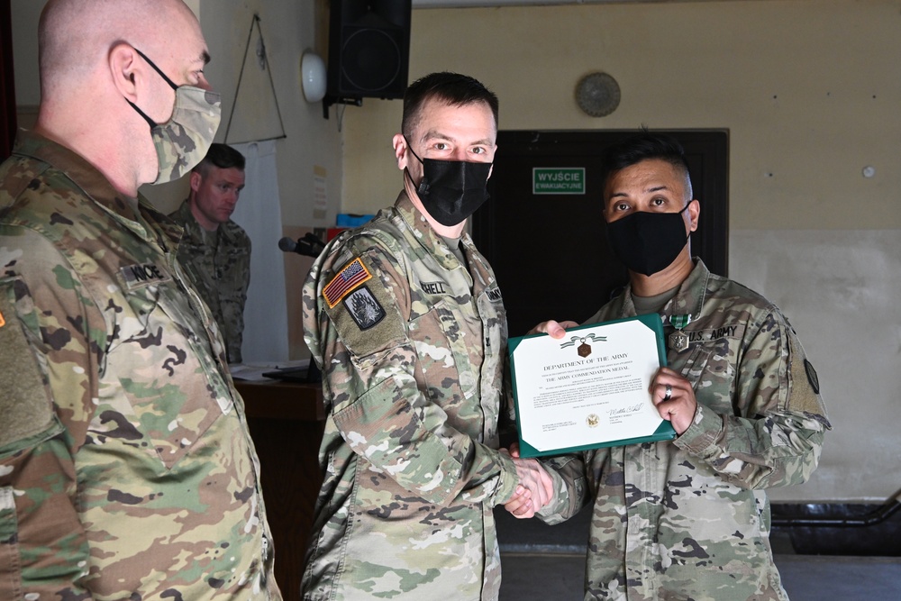 Alaska Army National Guard Sergeant Randy Briones, 297th Regional Support Group, receives an Army Commendation Medal.