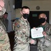 Alaska Army National Guard Sergeant Randy Briones, 297th Regional Support Group, receives an Army Commendation Medal.