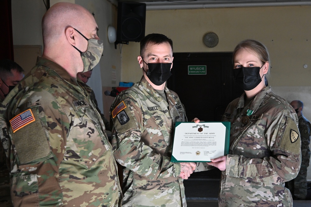 Alaska Army National Guard First Lieutenant Balinda Dresel, 297th Regional Support Group, receives an Army Commendation Medal.